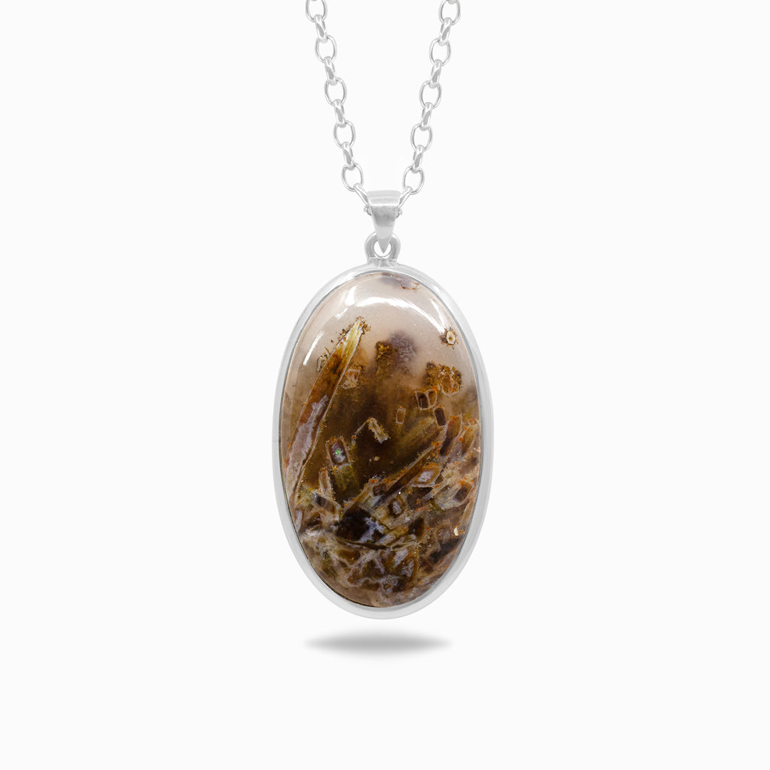 Silver necklace with a brown stone on a white background