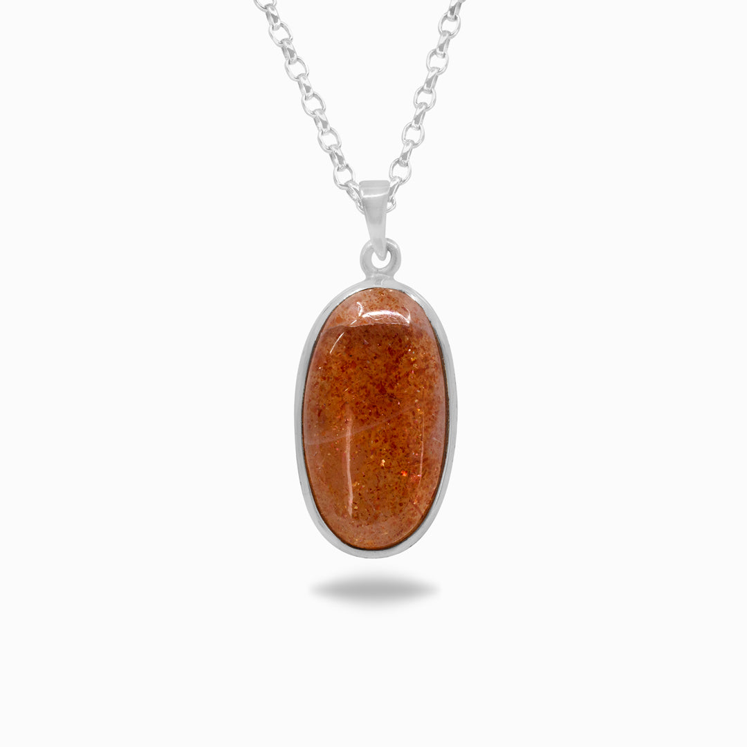 Silver necklace with an orange stone on a white background