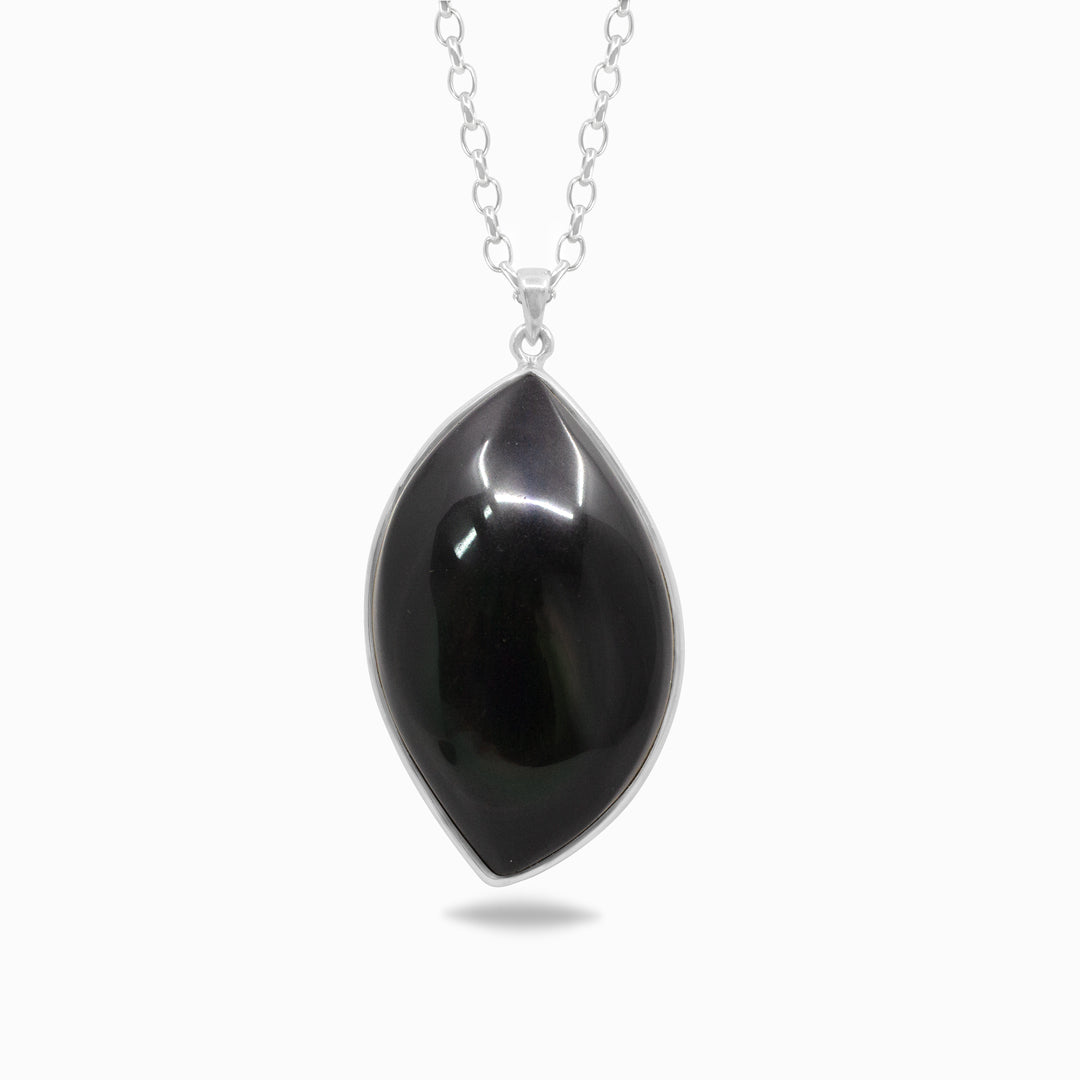 Silver necklace with a black stone on a white background