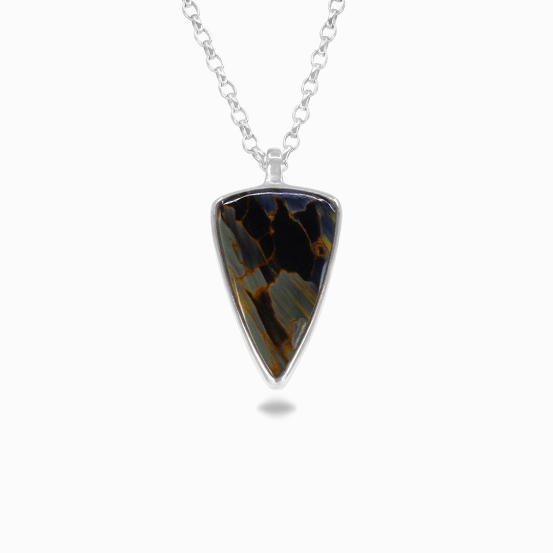 Silver necklace with a stone with dark blue patterns on a white background