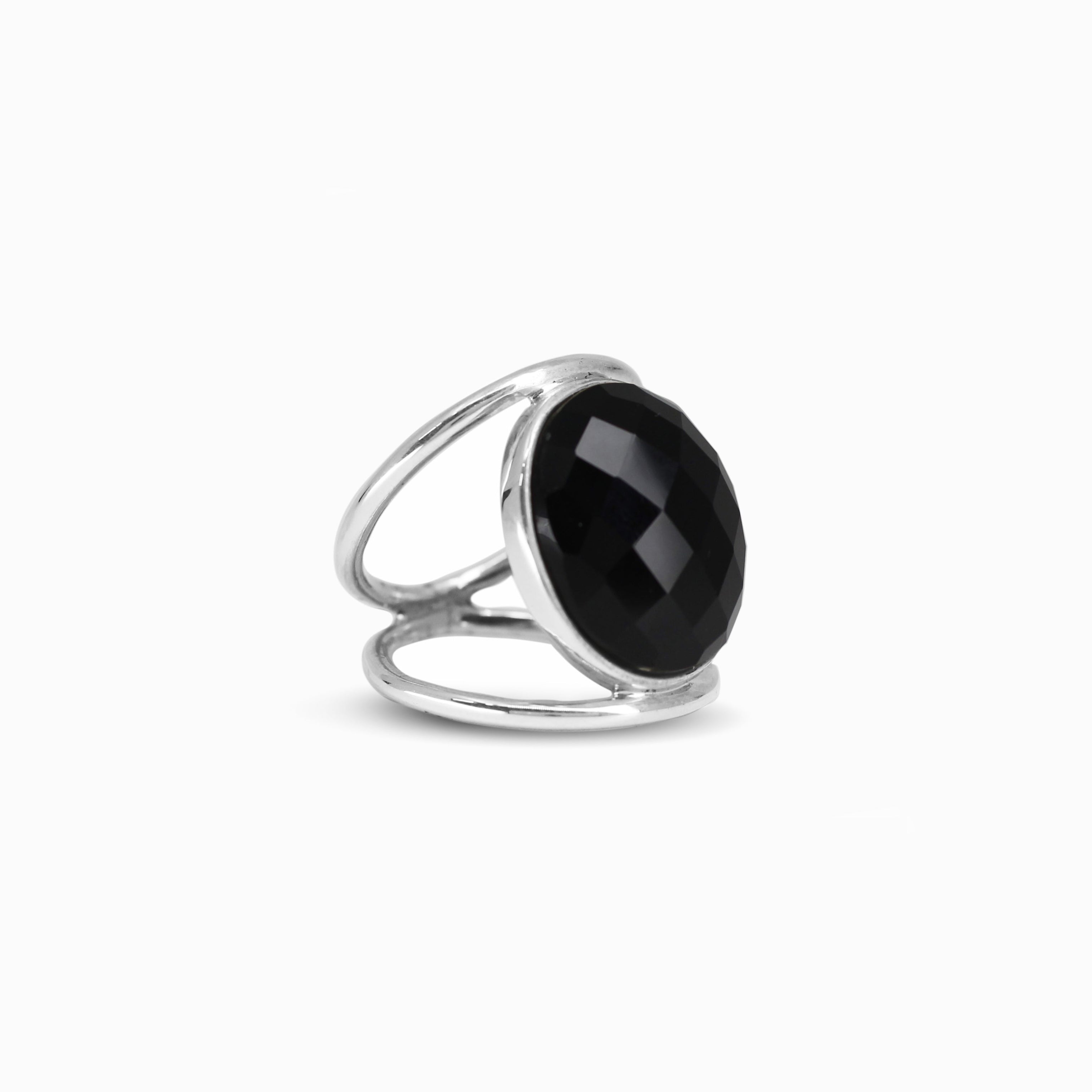 Silver ring with a black gemstone on a white background