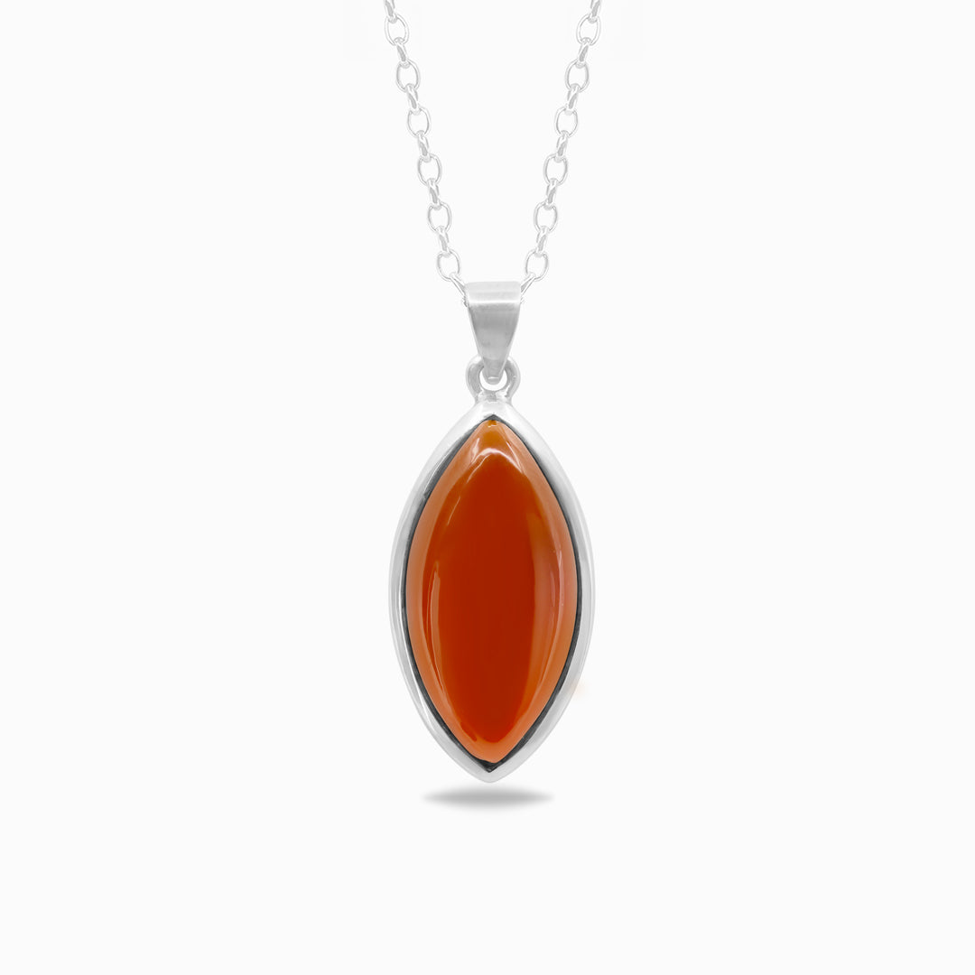 A silver pendant necklace featuring an orange gemstone against a white background.