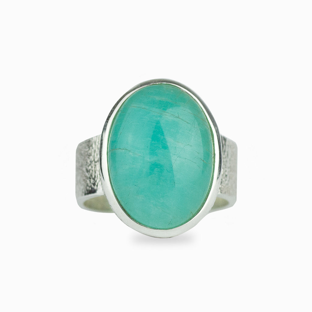 Teal coloured crystal, cabochon cut, 925 sterling silver bezel set, with a hammered detail band