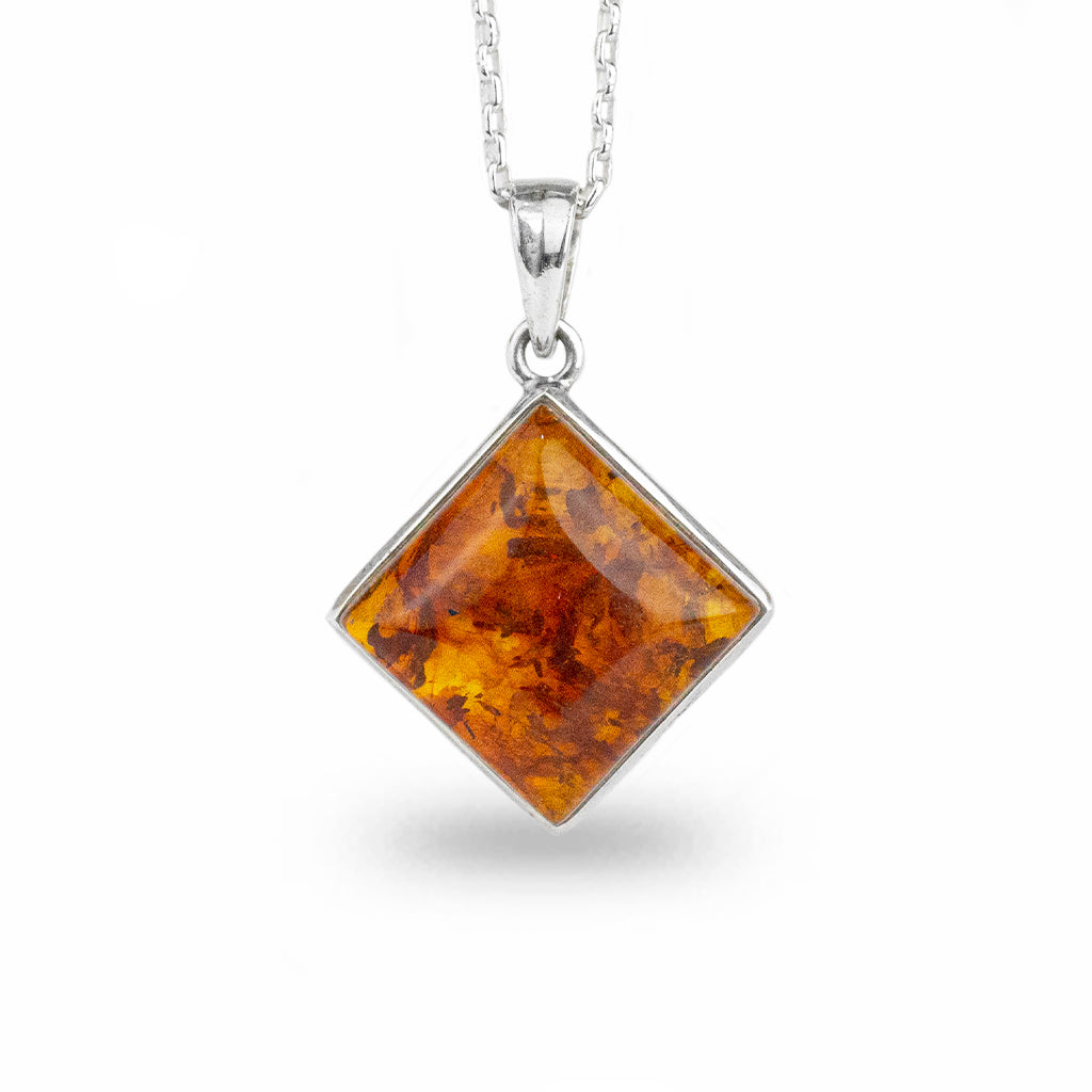 fiery orange, cabochon, bezel set square pendant, hanging from a corner 